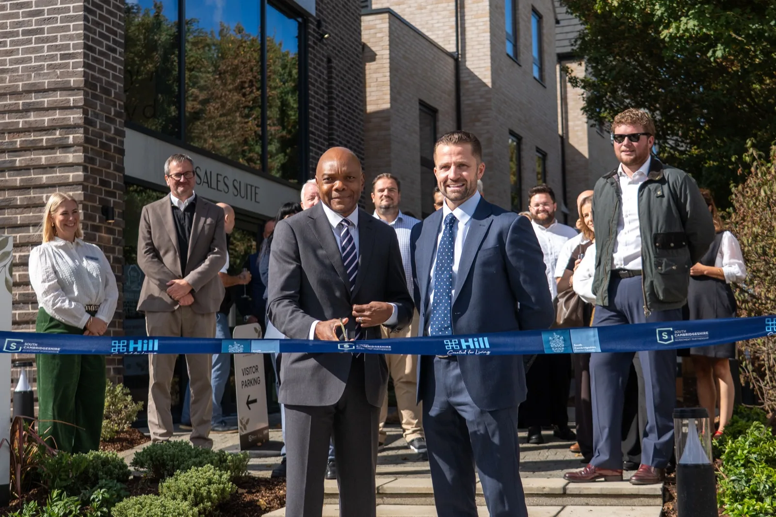 Bode Esan of South Cambridgeshire District Council and Tom Hill, managing director of The Hill Group, cut the ribbon outside the Cambium Square sales suite on 17 September.